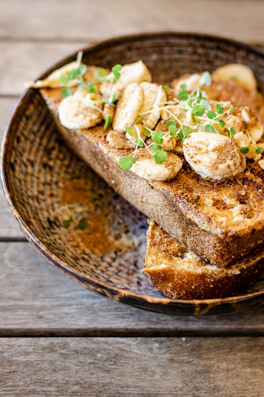 French Toast with bananas, maple syrup and leafy greens