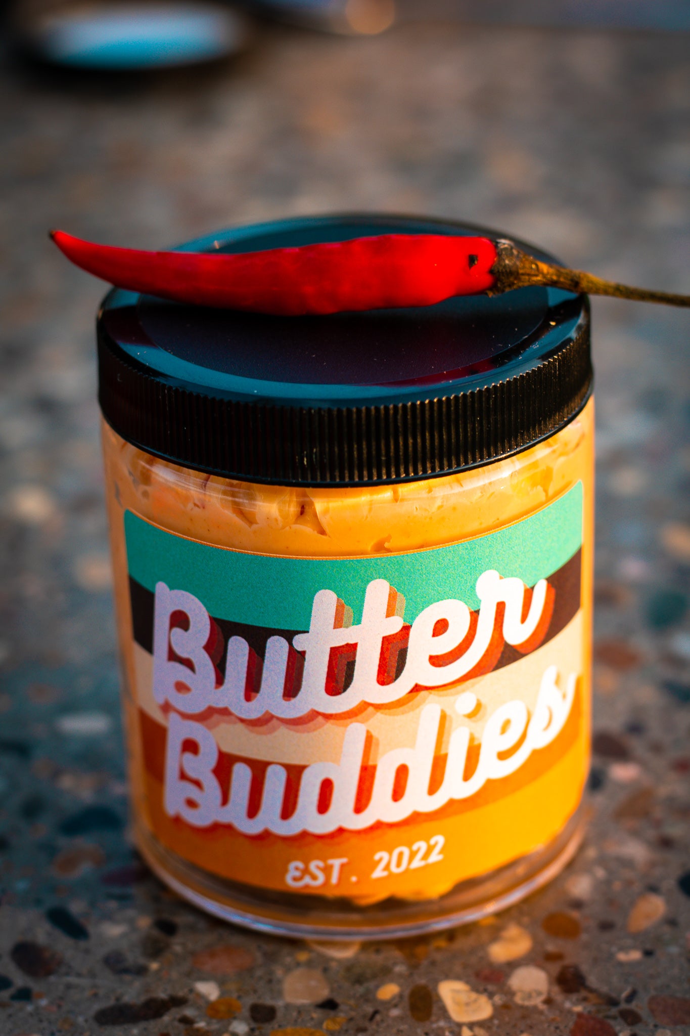 Honey Chili Flavoured butter, in a jar with a hot pepper on top.
