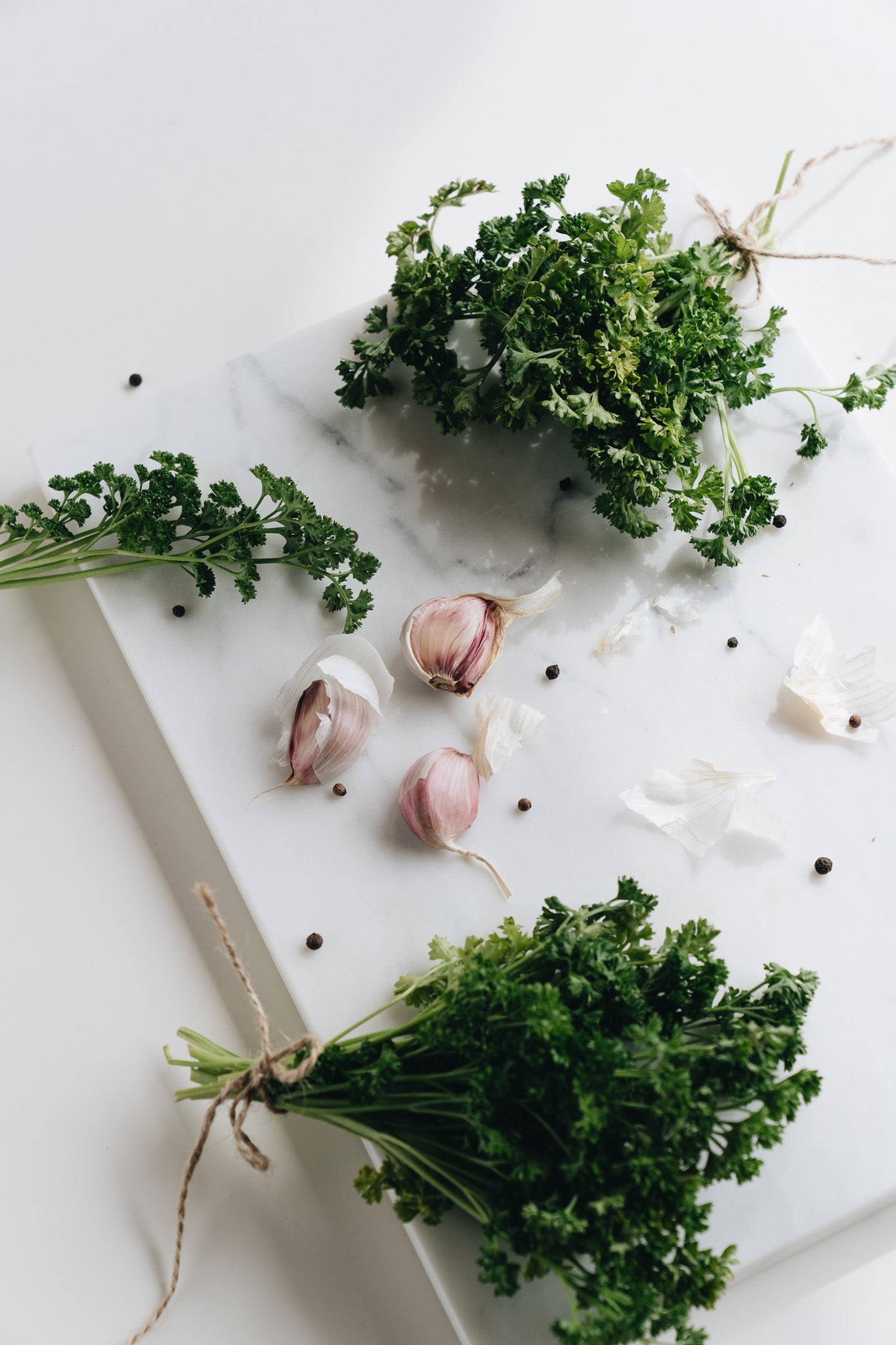 Garlic, Dill and other herbs on a cutting board ready to be put into flavoured butter.